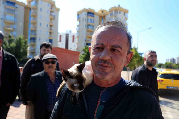 ALEV TOPUNA DÖNEN ARAÇTAN KEDİSİYLE BİRLİKTE SON ANDA ÇIKTI: SAHİBİNİN OMUZUNDAN BİR AN OLSUN AYRILMADI